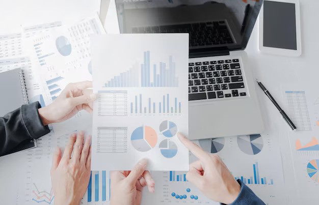 high-angle-view-business-people-discussing-graphs-desk_1048944-28710182-ezgif.com-avif-to-jpg-converter